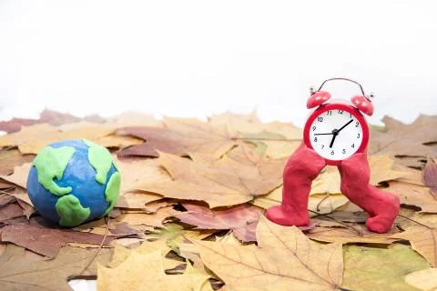 Daylight Saving Time. Wall Clock going to winter time. Autumn abstraction. Stock Photos