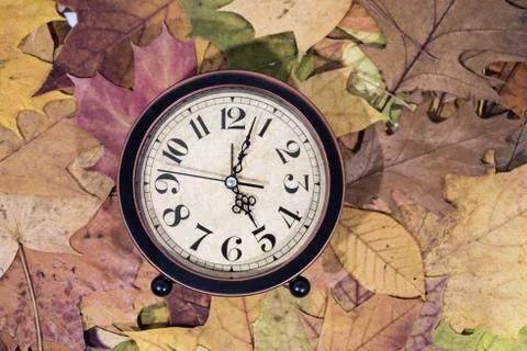 Daylight Saving Time. Wall Clock going to winter time. Stock Photos
