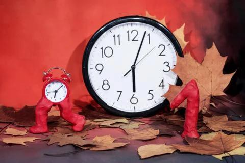 Daylight Saving Time. Wall Clock going to winter time. Stock Photos