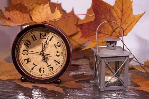 Daylight Saving Time. Wall Clock going to winter time. Autumn abstraction. Stock Photos