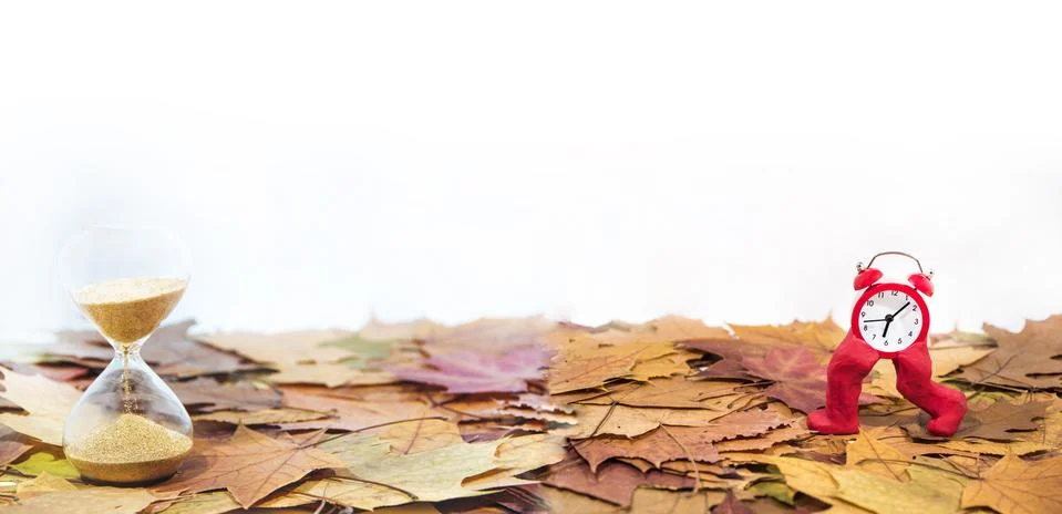 Daylight Saving Time. Wall Clock going to winter time. Autumn abstraction. Stock Photos