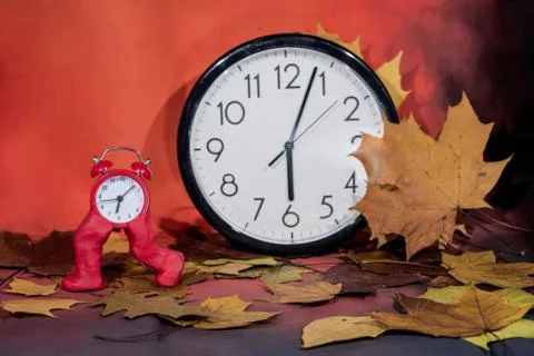 Daylight Saving Time. Wall Clock going to winter time. Autumn abstraction. Stock Photos