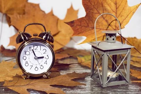 Daylight Saving Time. Wall Clock going to winter time. Autumn abstraction. Stock Photos