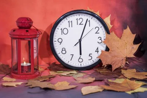 Daylight Saving Time. Wall Clock going to winter time. Autumn abstraction. Stock Photos