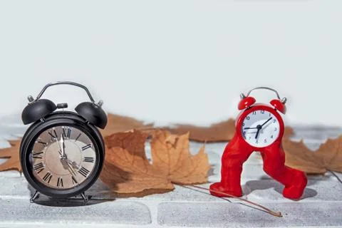 Daylight Saving Time. Wall Clock going to winter time. Autumn abstraction. Stock Photos