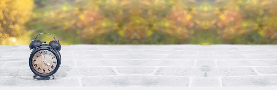 Daylight Saving Time. Wall Clock going to winter time. Autumn abstraction. Stock Photos