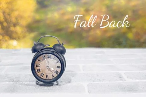Daylight Saving Time. Wall Clock going to winter time. Autumn abstraction. Stock Photos