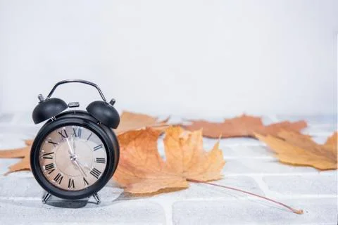 Daylight Saving Time. Wall Clock going to winter time. Autumn abstraction. Fa Stock Photos