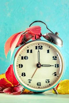Daylight Savings Time concept, fall back in autumn. A vintage alarm clock Stock Photos