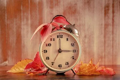 Daylight Savings Time concept, fall back in autumn, toned image. A vintage alarm 스톡 사진