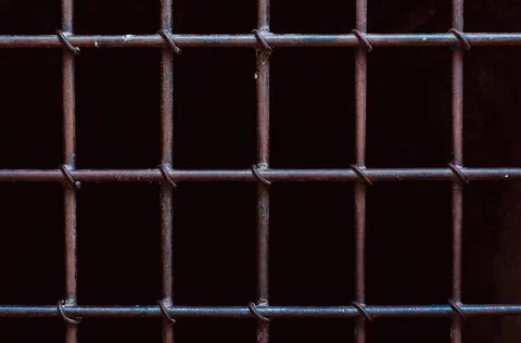 Daylight seen through iron prison bars Stock Photos
