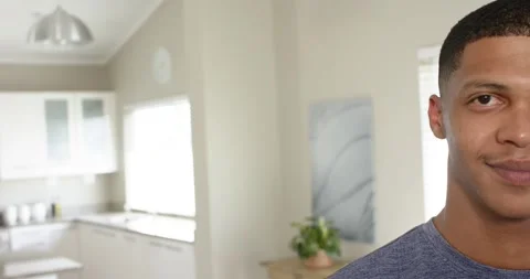 Daylight streaming through window drawing man standing in kitchen and smiling Stock Footage 336844583