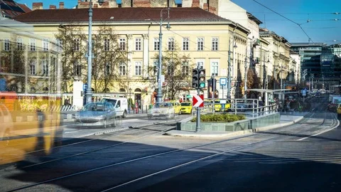 Daylight time lapse of busy intersection with cars and tram Stock Footage 70261606