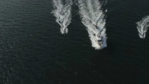 Days at sea, with top down drone shot of rib, jet skis and a super yacht Stock Footage 143037588