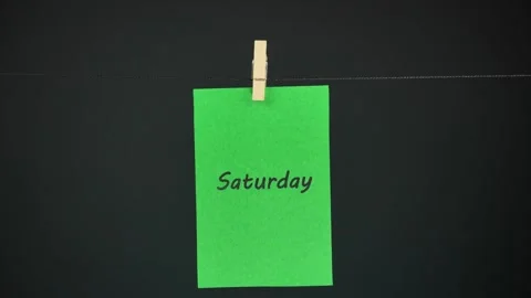 Days of the week attached to a clothespin on a string. Stop motion Video stock 294093180