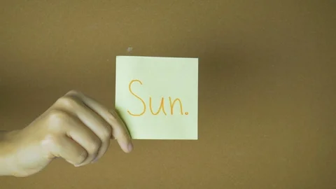 Days of week in motion. Hands passing each other sticky notes with letters funny Stock Footage 98856467