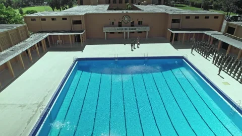Daytime Aerial Drone View Flying Back From Military Academy Swimming Pool in Stock Footage 345304600