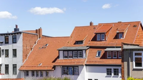 Daytime Clouds Drifting Above Ceramic Roofed Houses in Time-Lapse Stock Footage 121223017