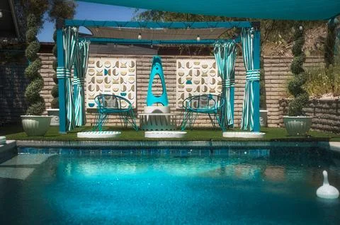 Daytime Desert Oasis Pool with Mid-Century Fireplace and Lounge Area Stock Photos