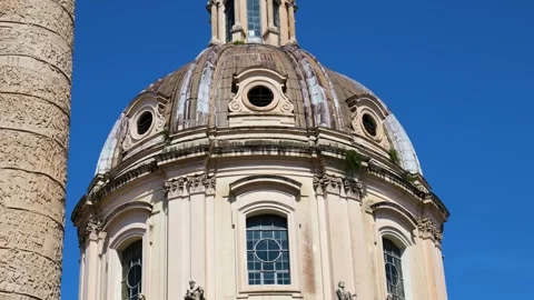 Daytime domed baroque church facade arched windows stone statues spiral relief Video stock 324894053