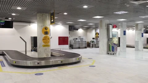 Daytime empty city airport baggage claim hall during COVID-19 outbreak Stock Footage 135869944