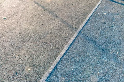 Daytime image of a gray-toned, linear pavement section with contrasting whi.. Stock Photos
