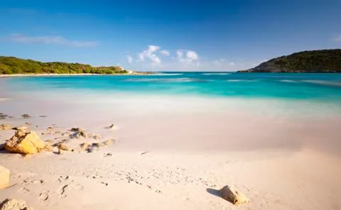 Daytime long exposure of the beautiful Half Moon Bay in Antigua. Stock Photos