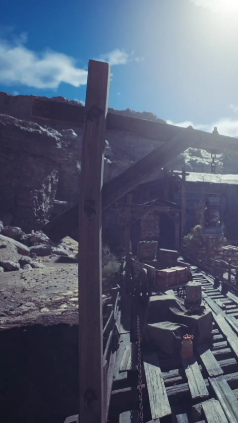 Daytime mining site with wooden structures and mountains behind Stock Footage 339042776