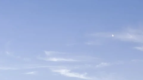 Daytime Moon in Blue Sky with Wispy Clouds Stock Footage 345922909