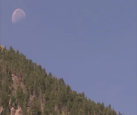 Daytime moon setting over Mickey Mouse Rock Stock Footage 86691316