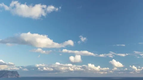 Daytime moving timelapse of fluffy Cumulus clouds, moving through the sky at Stock Footage 145973712