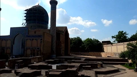 Daytime pan right of Gur-e-Amir Mausoleum and ancient brick ruins, Samarkand Stock Footage 336187955