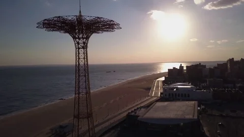 Daytime rising  tilting down shot Parachute Jump Tower Coney Island towards sun 動画素材 73313429