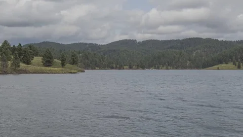 A Daytime Shot of Clouds and Traffic on South Dakota's Lake Pactola Stock Footage 113065095