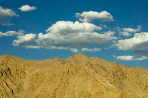 Daytime sky with clouds over the desert mountains Stock Photos