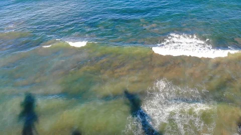 A daytime slow forward aerial view of a tropical ocean and white waves. Stock Footage 109313244