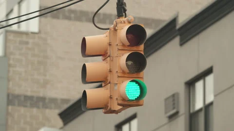 Daytime stoplight cycles through green red yellow lights Stock Footage 146414629