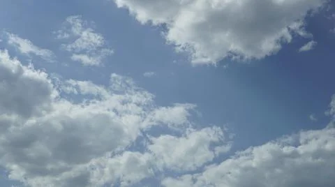 Daytime summer sky with drifting clouds over it Stock Photos