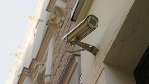Daytime Surveillance: CCTV Security Camera Monitors Building Wall Activity Stock Footage 243382605