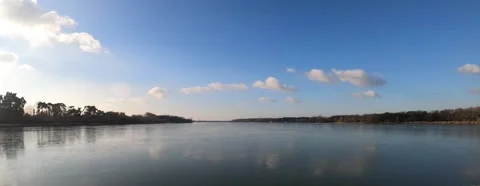Daytime time lapse of clouds above a lake Stock Footage
