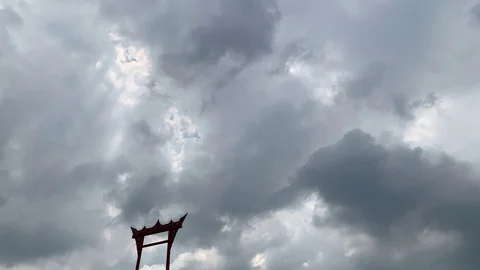 Daytime time lapse of clouds with sun rays passing over Asian-style edifice Stock Footage 117766682