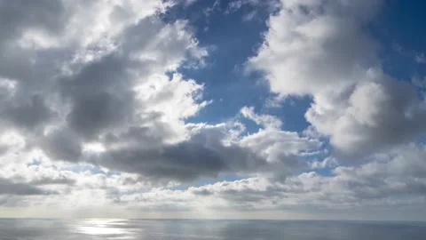 Daytime timelapse of fluffy Cumulus clouds, moving through the sky at different Stock Footage 145981188