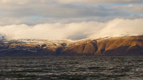 Daytime Timelapse of moving white clouds over lake Sevan on background hills. Stock Footage 98488627
