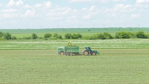 Daytime Tractor Movement in Wheat Field Farming Equipment in Action in Bulgaria Stock Footage 310367535