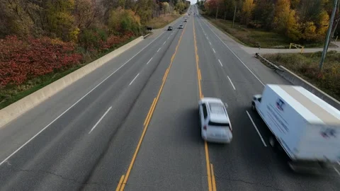 Daytime traffic on large road passing through forest area. Stock Footage 143933533