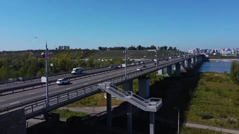 Daytime traffic on a multi-lane road at the entrance to the city via the bridge Stock Footage 195829749