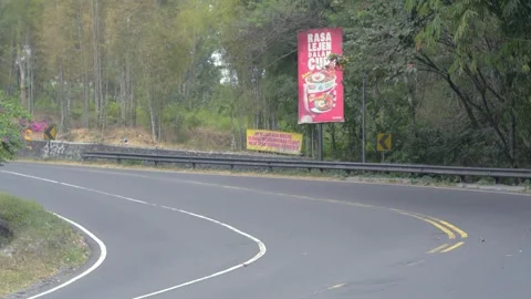 Daytime traffic at the Pathuk bend, Gunungkidul, Yogyakarta Stock Footage 314367261