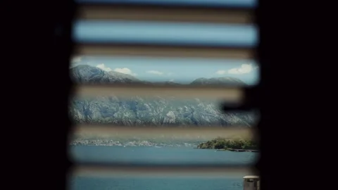 Daytime view of Bay of Kotor through Venetian blinds, Montenegro Vídeo Stock 329412818