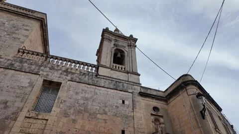 A daytime view of the bell tower of St. Paul's Church in Rabat, Malta Stock Footage 317178267