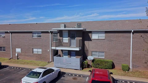 Daytime view of a brick multifamily housing building with satellite dish, Vídeo Stock 340925420